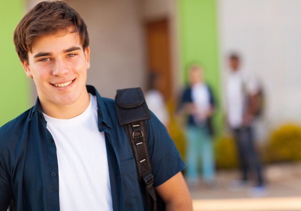 bigstock-smiling-teen-boy-carrying-scho-46806349